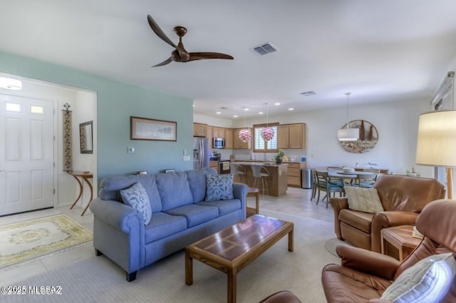 living room featuring a ceiling fan, light tile patterned flooring, visible vents, and recessed lighting