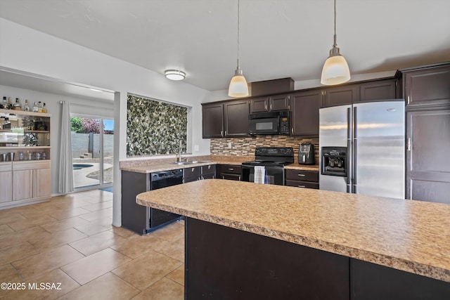 9061 E 39th St, Tucson, AZ 85730 - kitchen with pendant lighting, light countertops, a sink, backsplash, and black appliances
