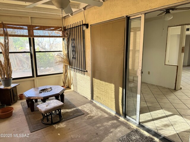 sunroom with a wealth of natural light and ceiling fan