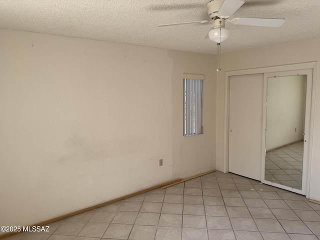 unfurnished bedroom with a ceiling fan, a textured ceiling, and a closet