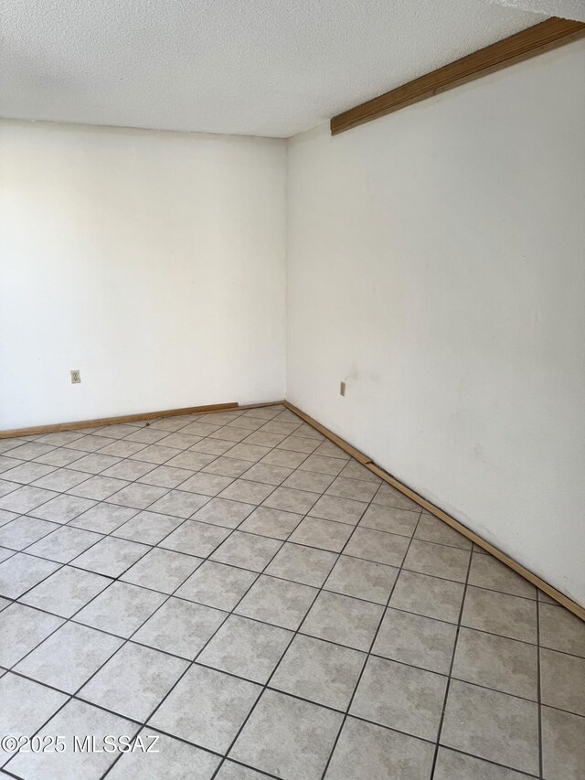 unfurnished room featuring a textured ceiling
