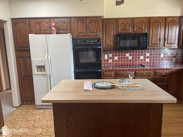 942 N Rancho Del Jefe Loop, Tucson, AZ 85748 - kitchen with black appliances, tile counters, decorative backsplash, and a center island
