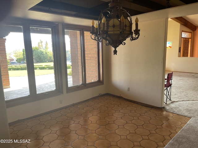 942 N Rancho Del Jefe Loop, Tucson, AZ 85748 - unfurnished dining area with plenty of natural light, a chandelier, beam ceiling, and dark flooring
