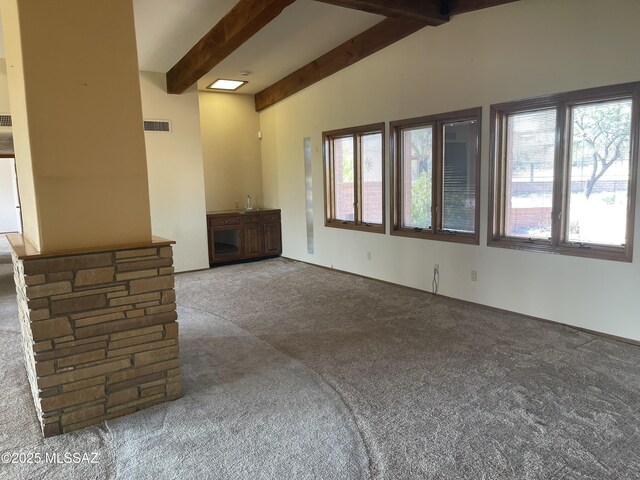 942 N Rancho Del Jefe Loop, Tucson, AZ 85748 - unfurnished living room featuring carpet flooring and beam ceiling