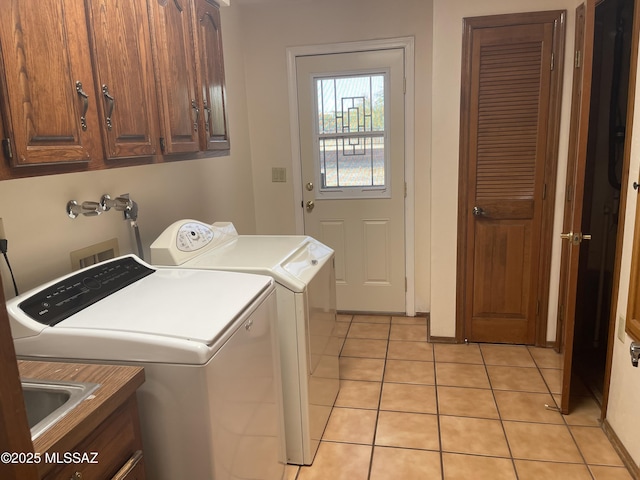 942 N Rancho Del Jefe Loop, Tucson, AZ 85748 - laundry area with cabinet space, washer and clothes dryer, and light tile patterned floors
