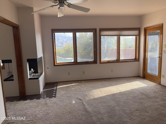 942 N Rancho Del Jefe Loop, Tucson, AZ 85748 - unfurnished living room with carpet floors and ceiling fan