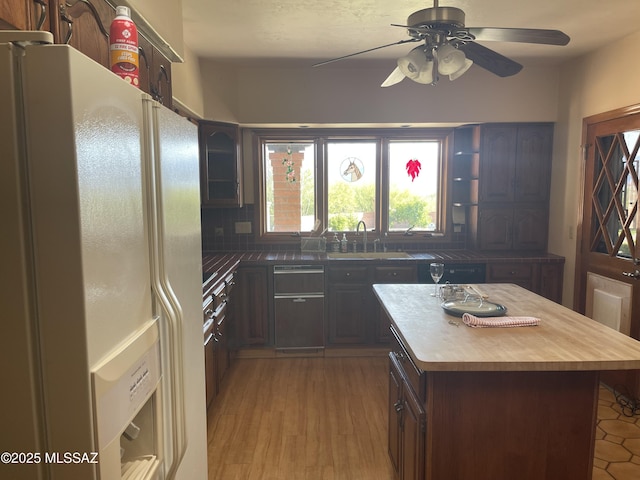 942 N Rancho Del Jefe Loop, Tucson, AZ 85748 - kitchen with white refrigerator with ice dispenser, a sink, a ceiling fan, butcher block counters, and backsplash