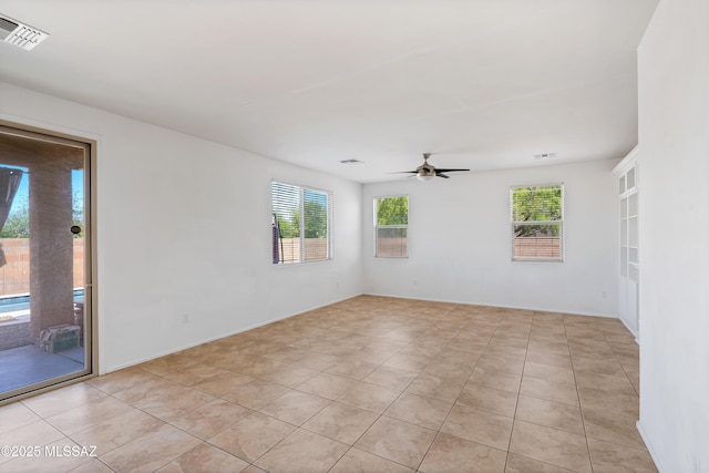 spare room with visible vents, a ceiling fan, and light tile patterned floors