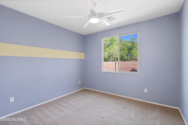 empty room featuring ceiling fan, baseboards, visible vents, and carpet