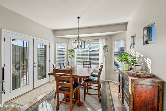 9224 S Big Tree Ln, Tucson, AZ 85756 - dining area featuring a chandelier, baseboards, and french doors