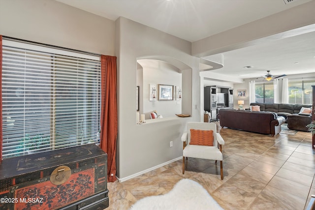 9224 S Big Tree Ln, Tucson, AZ 85756 - living area with arched walkways, visible vents, tile patterned floors, and ceiling fan