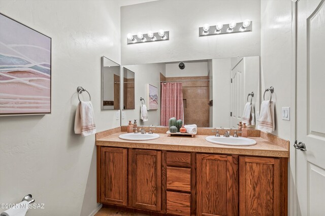 9224 S Big Tree Ln, Tucson, AZ 85756 - bathroom featuring a sink, a shower with shower curtain, and double vanity