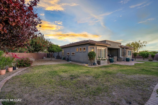 9224 S Big Tree Ln, Tucson, AZ 85756 - rear view of property featuring a fenced backyard, a patio, and a lawn