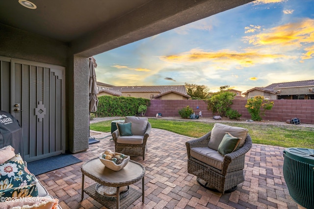 9224 S Big Tree Ln, Tucson, AZ 85756 - patio terrace at dusk featuring a fenced backyard and an outdoor living space