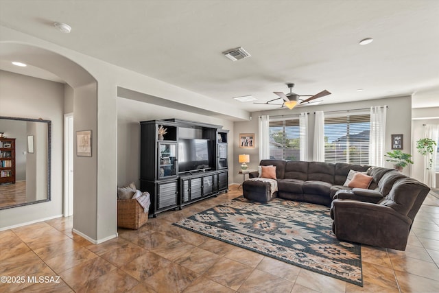 9224 S Big Tree Ln, Tucson, AZ 85756 - living room with baseboards, a ceiling fan, visible vents, and arched walkways