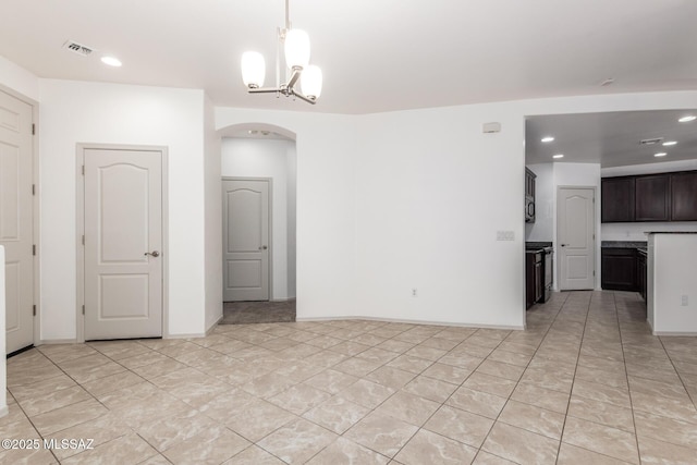 interior space with recessed lighting, arched walkways, light tile patterned floors, visible vents, and a notable chandelier