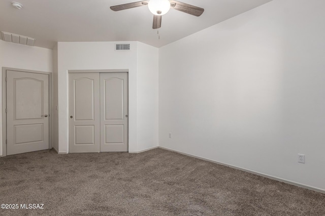 unfurnished bedroom featuring a closet, visible vents, a ceiling fan, and carpet