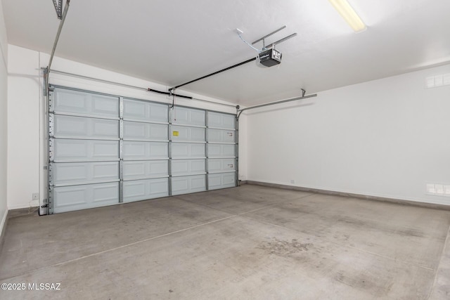 garage with a garage door opener and baseboards