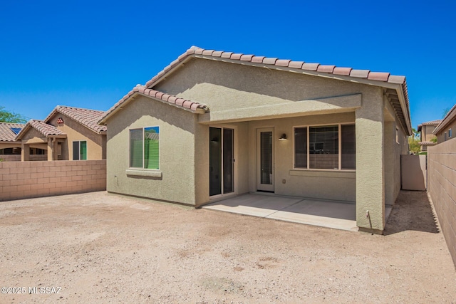 back of property with a patio, stucco siding, and a fenced backyard