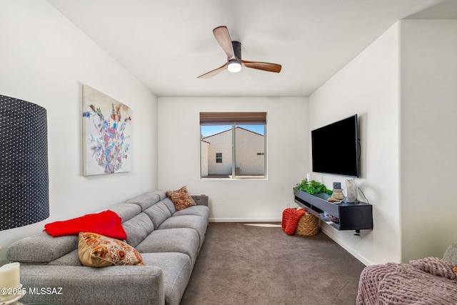 carpeted living room with ceiling fan and baseboards