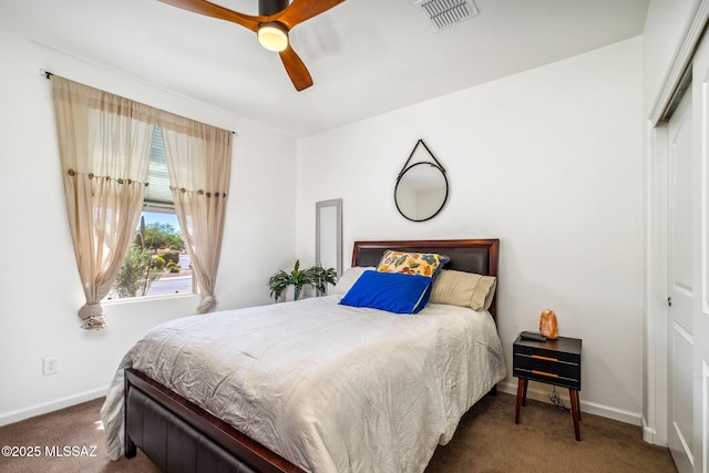 bedroom with baseboards, visible vents, and carpet