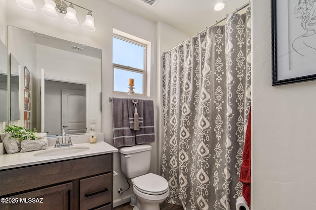 full bath with visible vents, vanity, curtained shower, and toilet