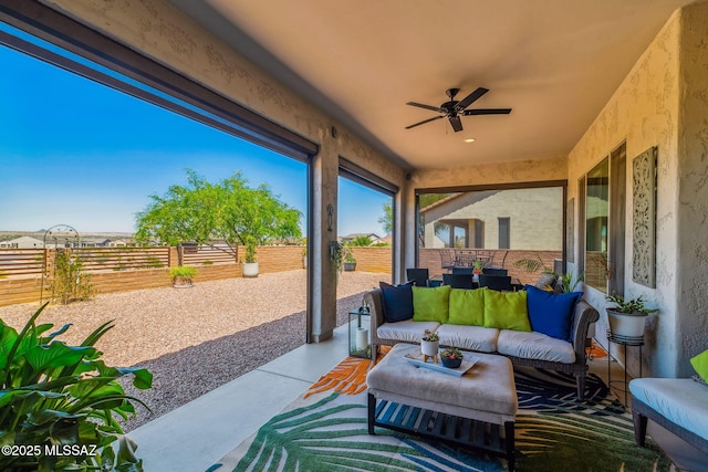 view of patio with an outdoor living space, ceiling fan, and a fenced backyard