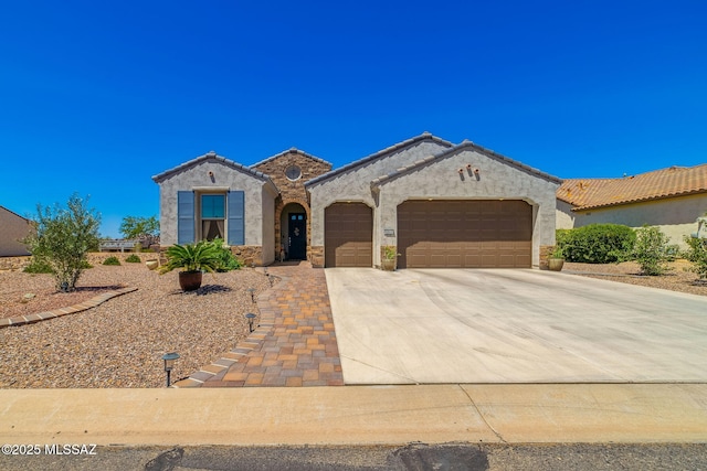 view of front of home with an attached garage, a tile roof, stucco siding, and concrete driveway