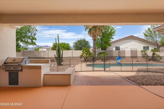 view of patio / terrace featuring a fenced backyard, area for grilling, and a fenced in pool