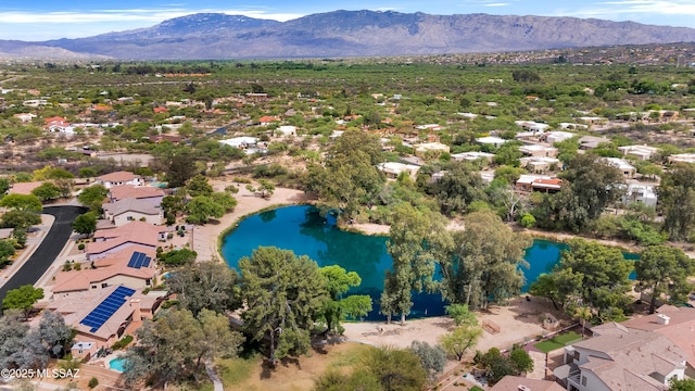 birds eye view of property featuring a water and mountain view and a residential view