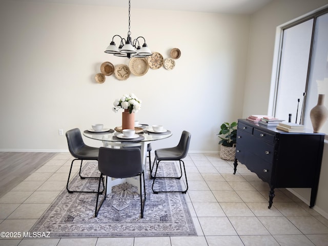 dining area featuring baseboards, a chandelier, and light tile patterned floors