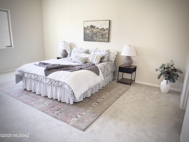 bedroom featuring baseboards and carpet