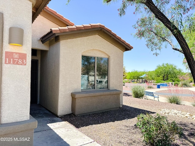 view of side of home with stucco siding