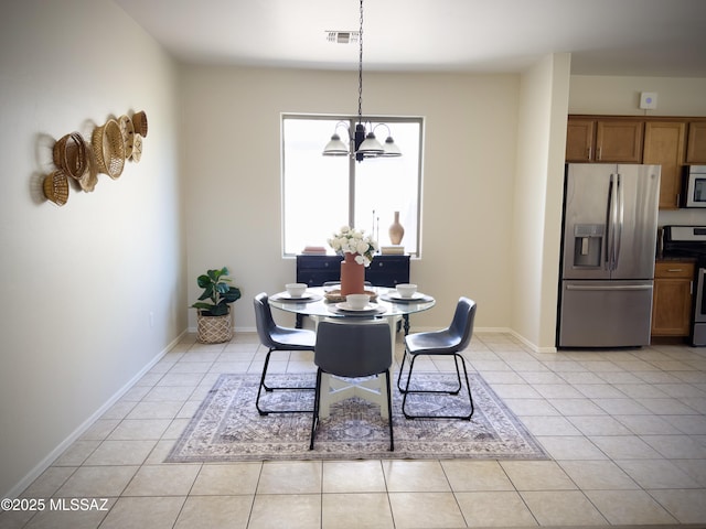 dining area with visible vents, baseboards, a notable chandelier, and light tile patterned flooring