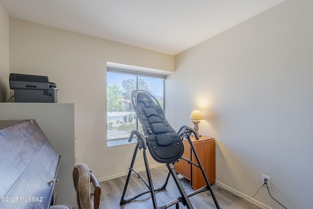 office space with wood finished floors and baseboards