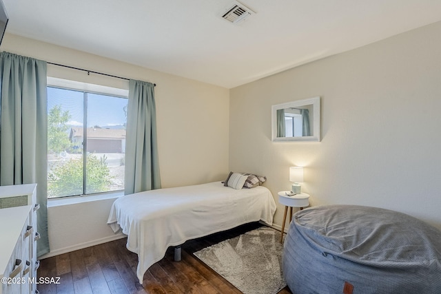 bedroom featuring baseboards, dark wood-type flooring, and visible vents