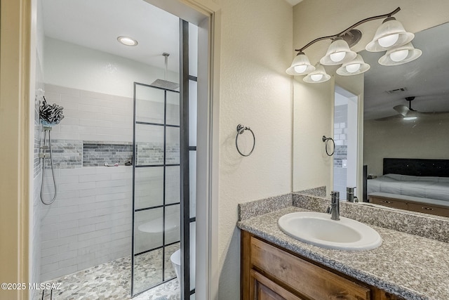 full bathroom with connected bathroom, vanity, visible vents, and a tile shower