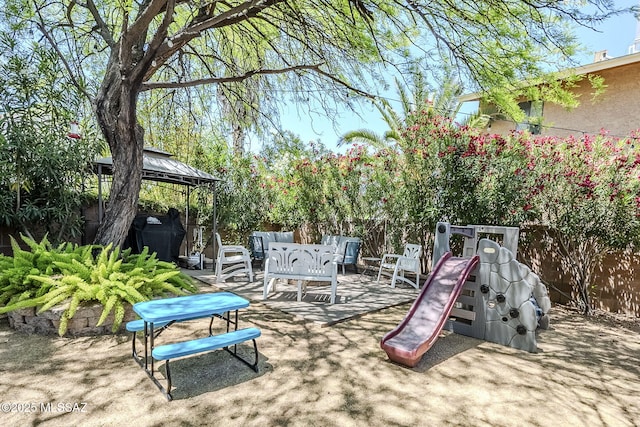 exterior space featuring a gazebo, fence, and a patio area