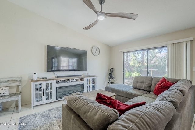 living room with a ceiling fan, light tile patterned floors, and lofted ceiling