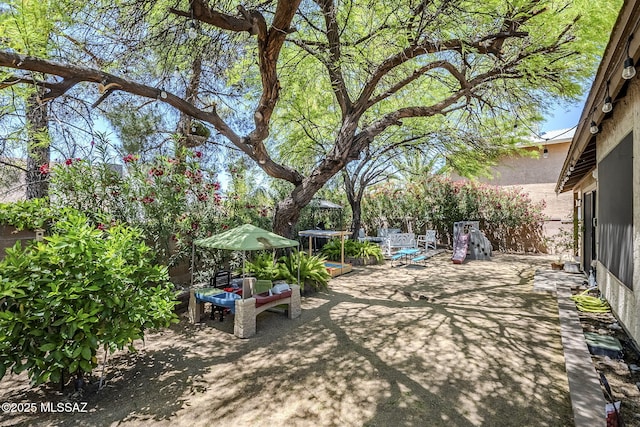 view of yard featuring a patio and fence