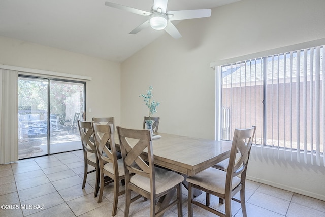 dining area with light tile patterned floors, lofted ceiling, and ceiling fan