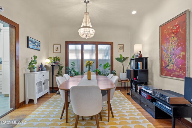 dining space featuring light wood-style floors, recessed lighting, baseboards, and a chandelier