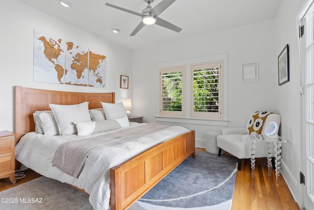 bedroom featuring baseboards, a ceiling fan, recessed lighting, and wood finished floors