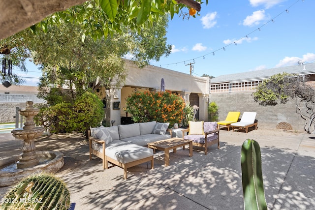 view of patio / terrace featuring an outdoor hangout area and fence