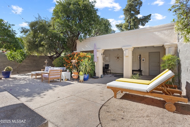 view of patio with outdoor lounge area and fence