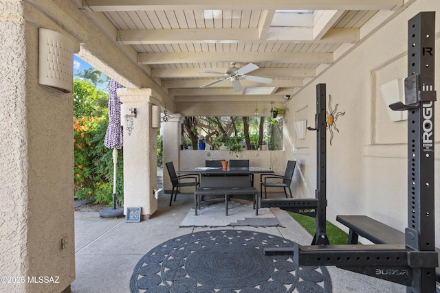view of patio featuring outdoor dining area and a ceiling fan