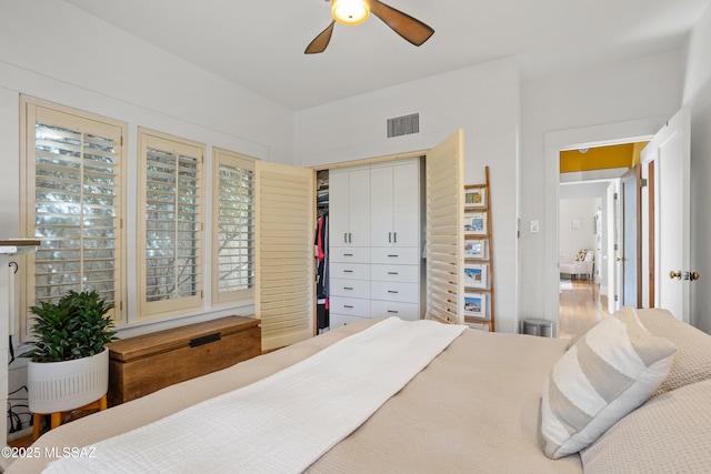 bedroom featuring visible vents, ceiling fan, and a closet
