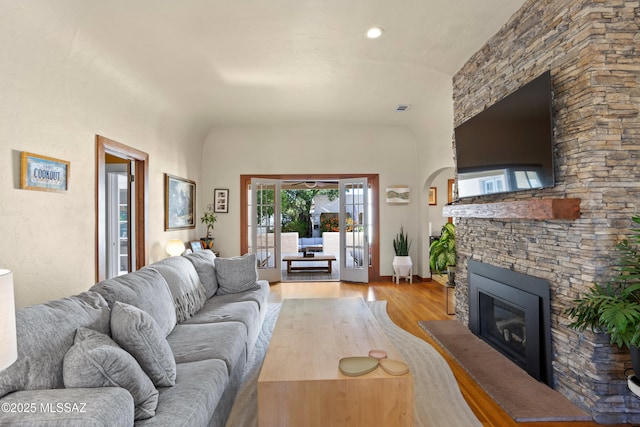 living room with light wood-style flooring and a fireplace