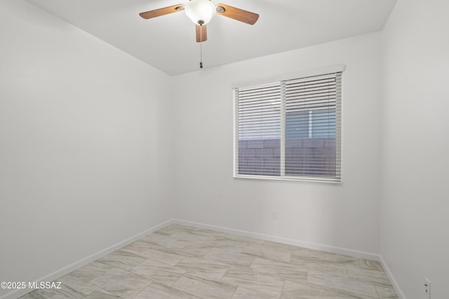 unfurnished room featuring baseboards, ceiling fan, and marble finish floor