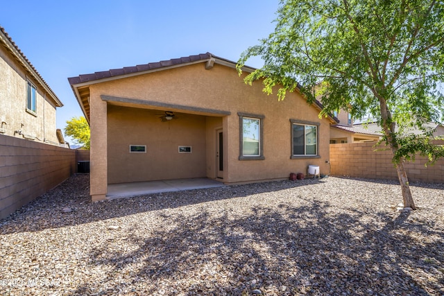 back of house with stucco siding, a patio area, ceiling fan, and a fenced backyard